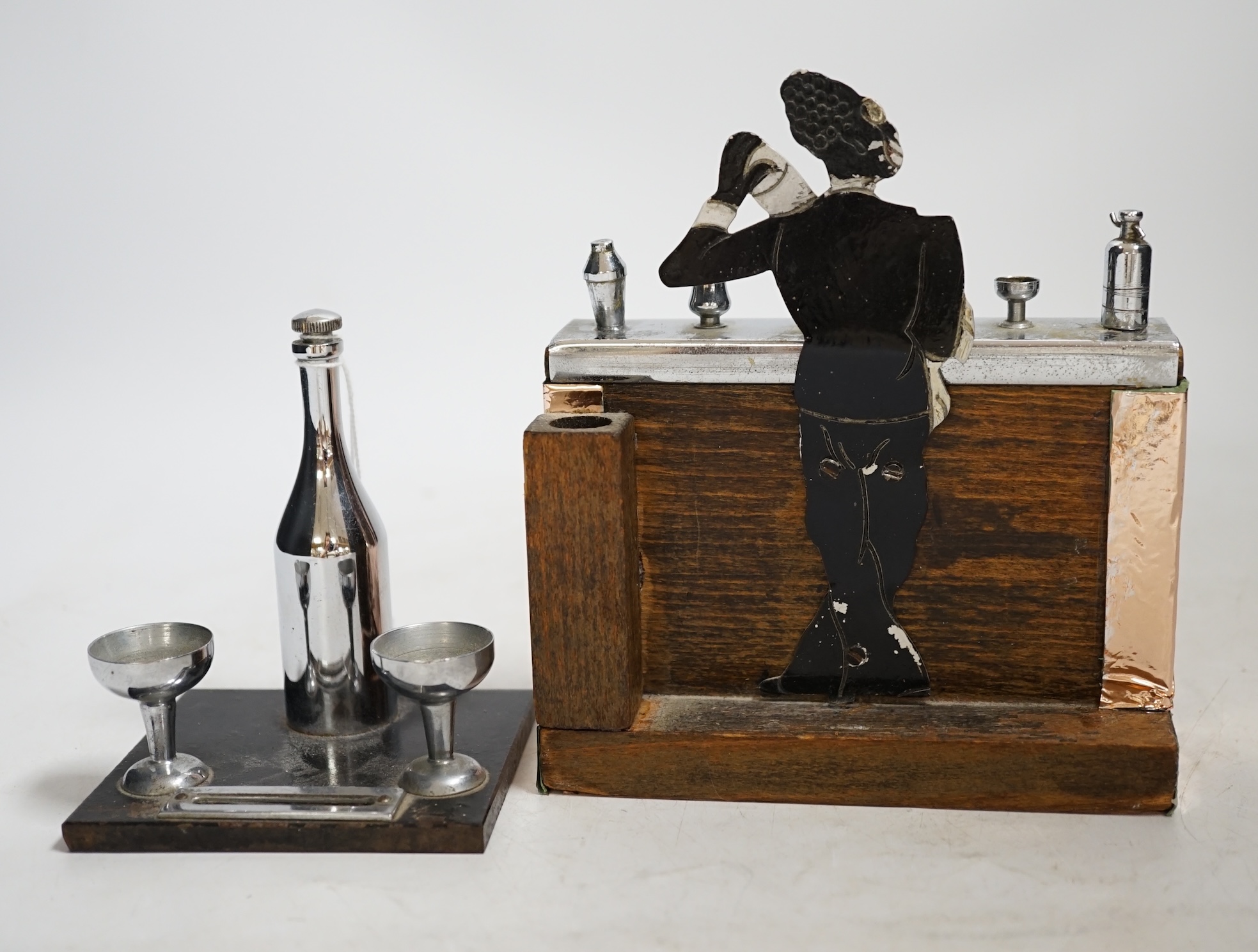 Two Art Deco match strikes, one in the form of a champagne bottle and two glasses, largest 13cm wide. Condition - fair